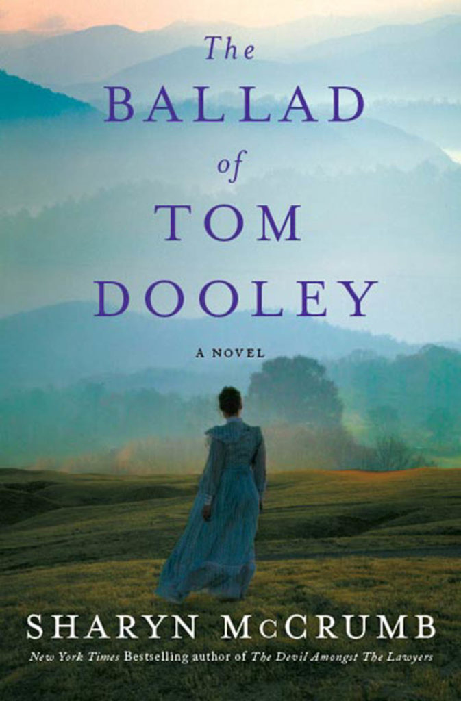 The Ballad of Tom Dooley cover shows a woman in 1800s dress from the back -- she is standing in a field looking towards the mountains in the distance.